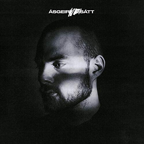 A black-and-white album cover featuring a man's face with a dark background.