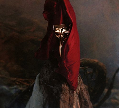 A golden plague doctor mask draped in red fabric against a dark, textured background.