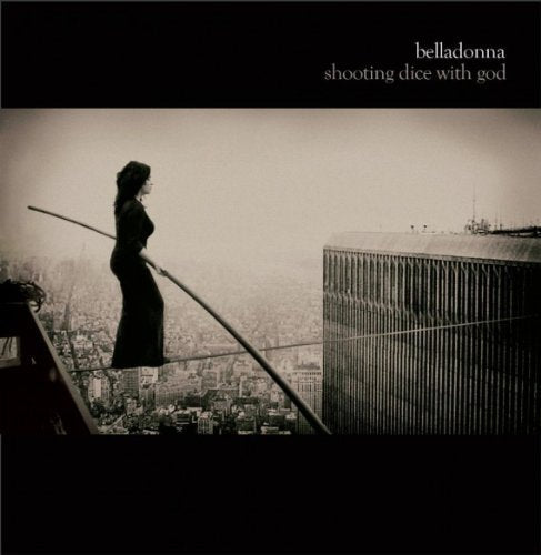 Black and white image of a woman walking on a tightrope between skyscrapers.