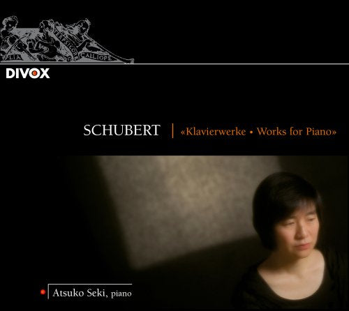 Atsuko Seki's CD cover featuring a woman with short black hair and a black top.