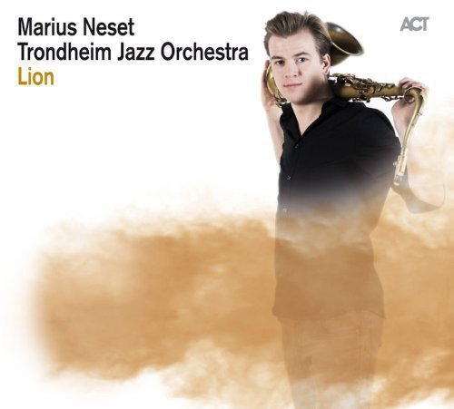 Man with saxophone against a blurred golden background, album cover.
