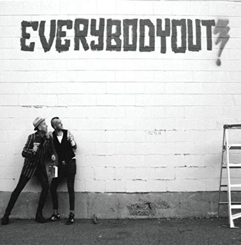 Black and white album cover featuring two people leaning against a brick wall.