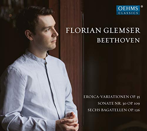 Man in white shirt standing by window, Beethoven CD cover with text and logo.