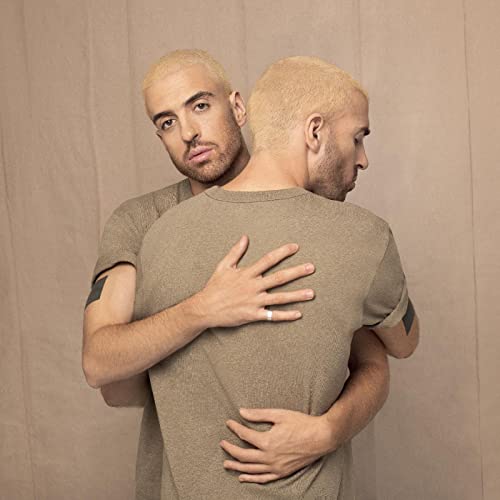 Man with blonde hair embracing his mirrored reflection, album cover.