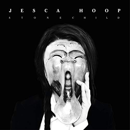 Black and white album cover featuring a person with a distorted mask.