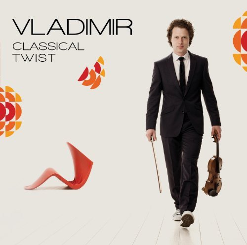 Man in a black suit holding a violin and bow on a white floor.
