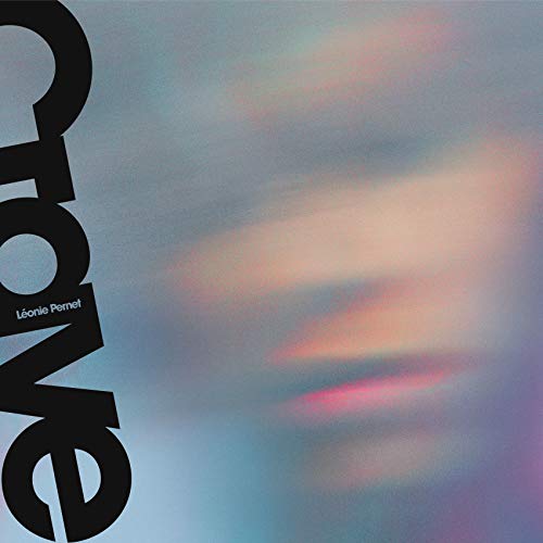 The image shows a vinyl record cover with the title "Crave" and artist "Léonie Pernet". The alt text is: "Vinyl record cover with 'Crave' title, cloudy background, and 'Léonie Pernet' name."