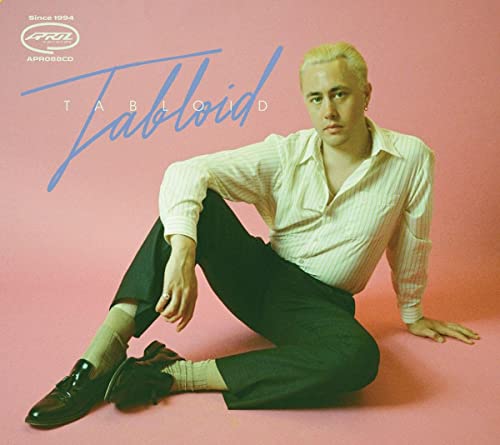 CD cover: man with short blonde hair in striped shirt, pink background.