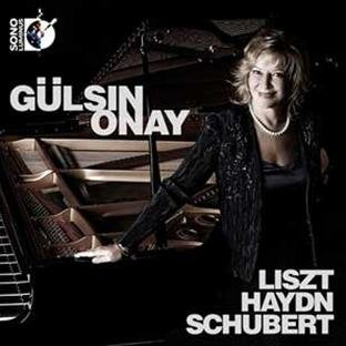 "CD cover featuring a woman standing beside a grand piano, wearing a black dress."
