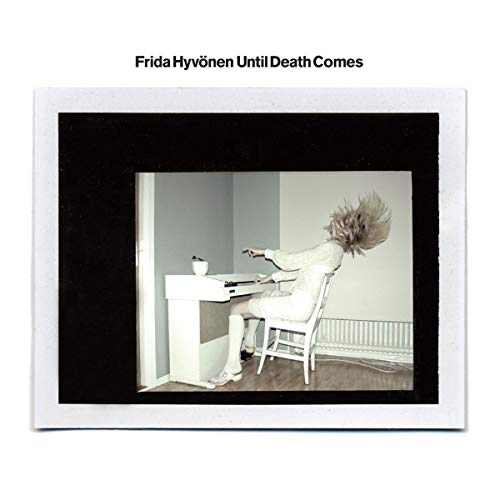 CD cover: woman seated at piano, hair flying, in a stark room.