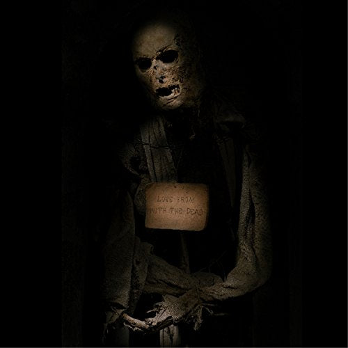 Masked figure holding a sign reading "Love From With The Dead".