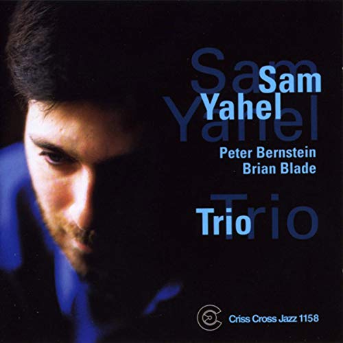 CD cover featuring Sam Yahel’s portrait and “Trio” title in blue text.