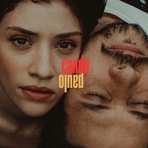 Close-up of two faces with text “Cande Paulo” overlaid in red and gold.