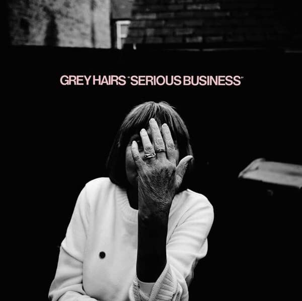 Black and white album cover with person covering face with hand.