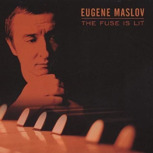 "CD cover with a man holding a lit stick of dynamite, orange glow."