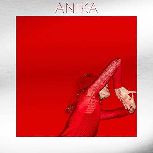 Red album cover featuring a woman in a red dress with outstretched arm.