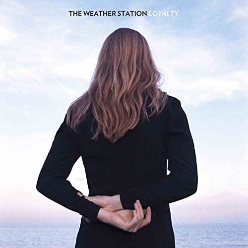 Vinyl album cover: woman with long hair facing the sea.
