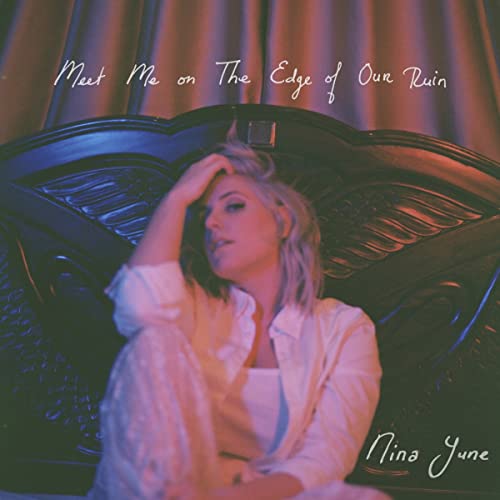 Album cover: woman in white, seated on a dark ornate sofa.