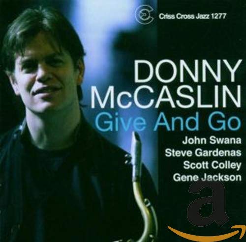 "CD cover with Donny McCaslin holding a saxophone, blue background, and white and blue text."