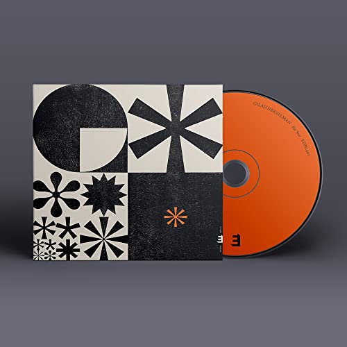 CD case and disc with abstract black and white geometric design.