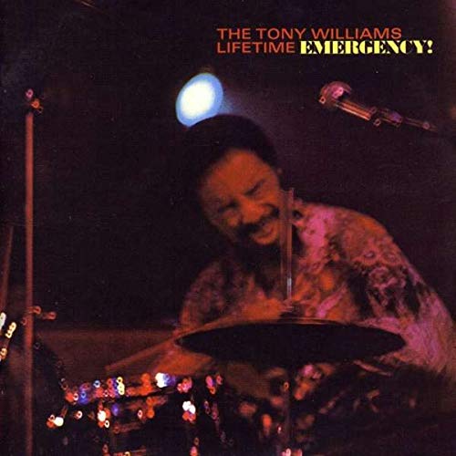 Tony Williams drumming, album cover for “Emergency!” with a dark background.