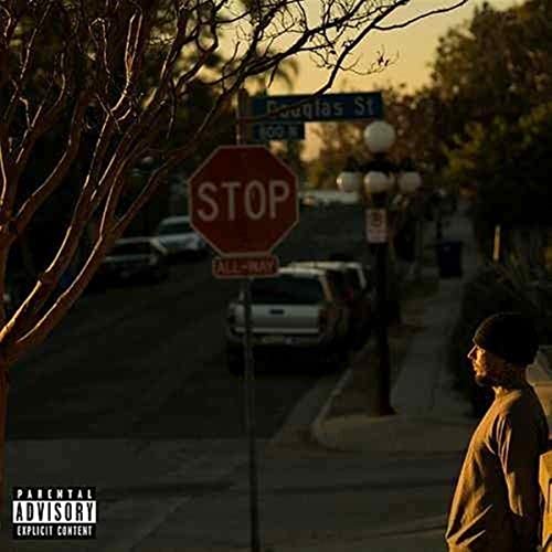 Street scene with stop sign, trees, cars, and a man in profile.