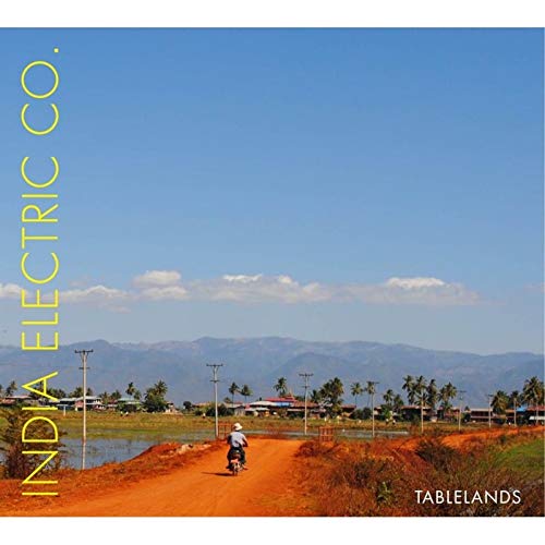 CD cover: rural landscape with a motorcyclist on a dirt road.