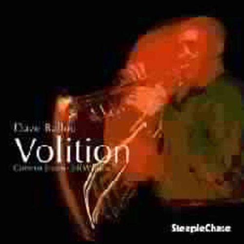"Blurry image of a man playing trumpet, with text 'Volition' on a black background."