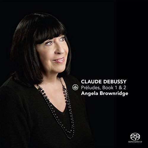 CD cover featuring a woman with dark hair and black clothing against a black background.