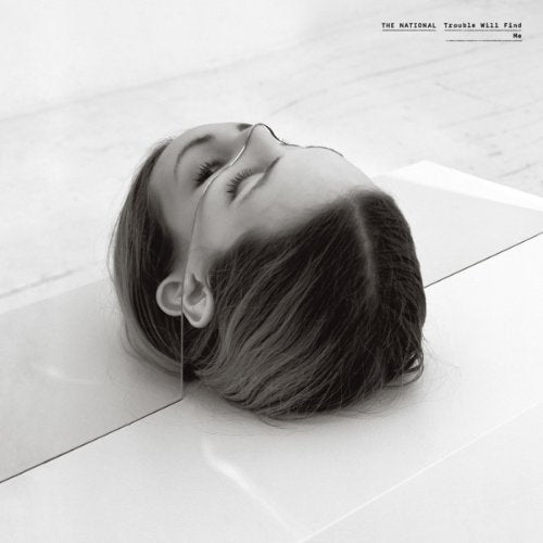 "Album cover featuring a black and white image of a woman's head on white tiles."