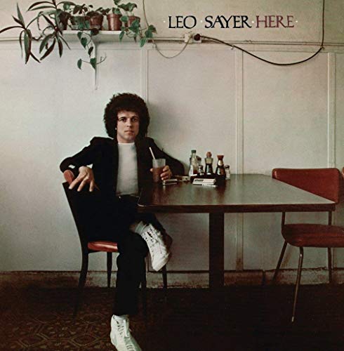 Album cover for Leo Sayer’s “Here” featuring a man at a diner table.