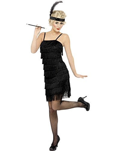 Woman in 1920s flapper costume, black fringe dress, fishnets, and feathered headband, holding a cigarette holder.