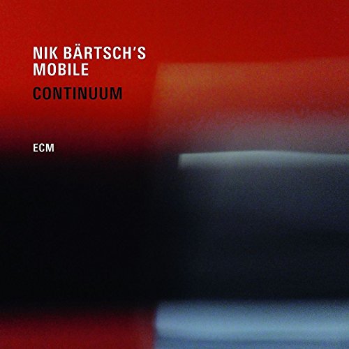 "Album cover with red background, white and black text, and blurred abstract shapes."