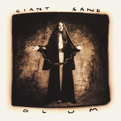 Album cover for Giant Sand’s “Glum” featuring a woman in dark robes and chains.