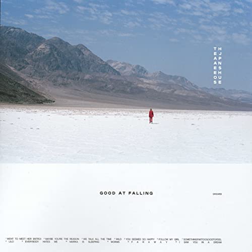 Album cover for “Good at Falling” featuring a lone figure in a desert landscape.