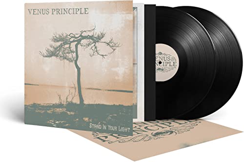 Vinyl record and album cover featuring a lone tree against a hazy sky.
