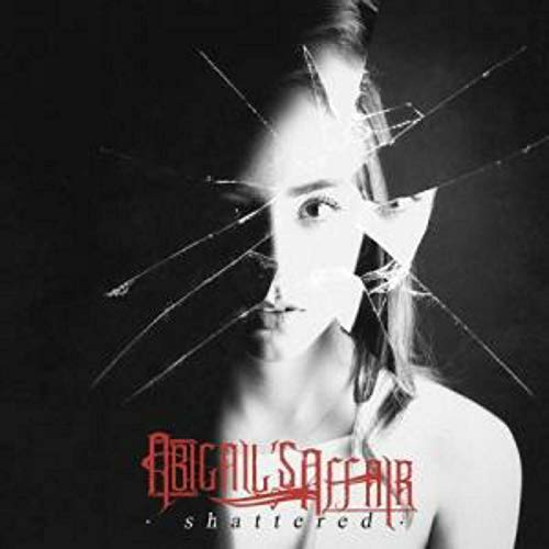 Black and white album cover with a woman's face behind broken glass.