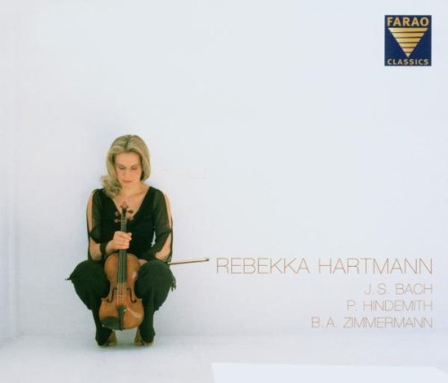 A woman in black clothing holds a violin, kneeling on a white background.