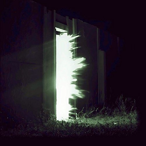 A compact disc with a white cover featuring a black-and-white image of a doorway.