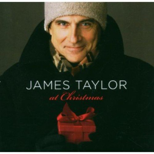 "James Taylor holding a red gift box, wearing a white knit hat, on album cover."
