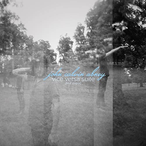 Black and white album cover with blurred figures in a park.