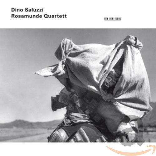 Black and white album cover featuring a person carrying large sacks.