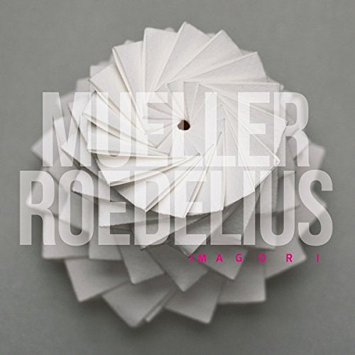 A white origami-like object on a gray background with superimposed text "Mueller Roedelius Imagori".