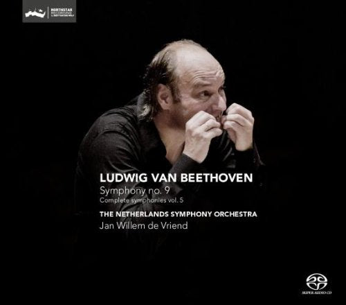 CD cover with a conductor holding batons, against a black background.