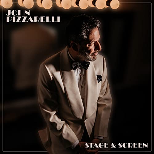 John Pizzarelli album cover, man in a light suit, stage lights.