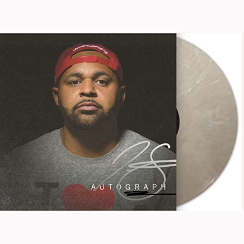 Vinyl record with album cover featuring a man in a red cap.