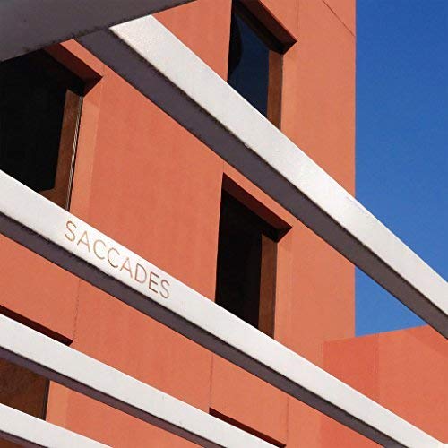 Red building facade with white angled beams and the word "SACCADES".