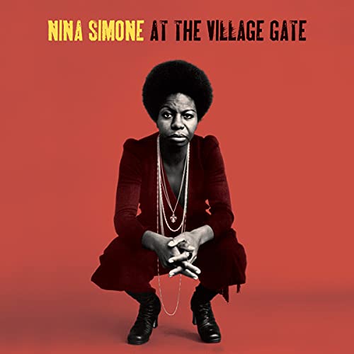Nina Simone crouches against a red background on this album cover.