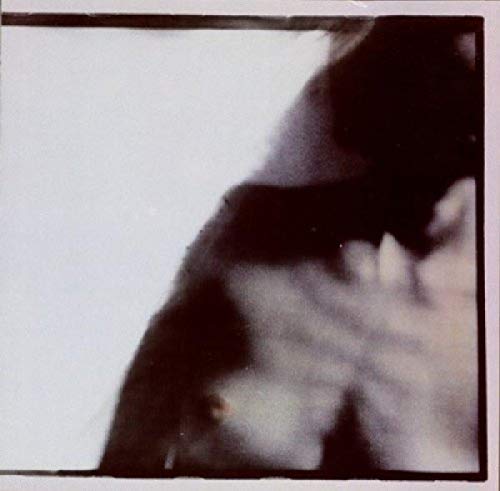 Blurred CD cover featuring a shadowy, indistinct face in profile.