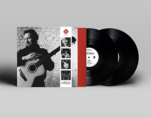 Vinyl record album cover with a man holding a guitar and two black records.